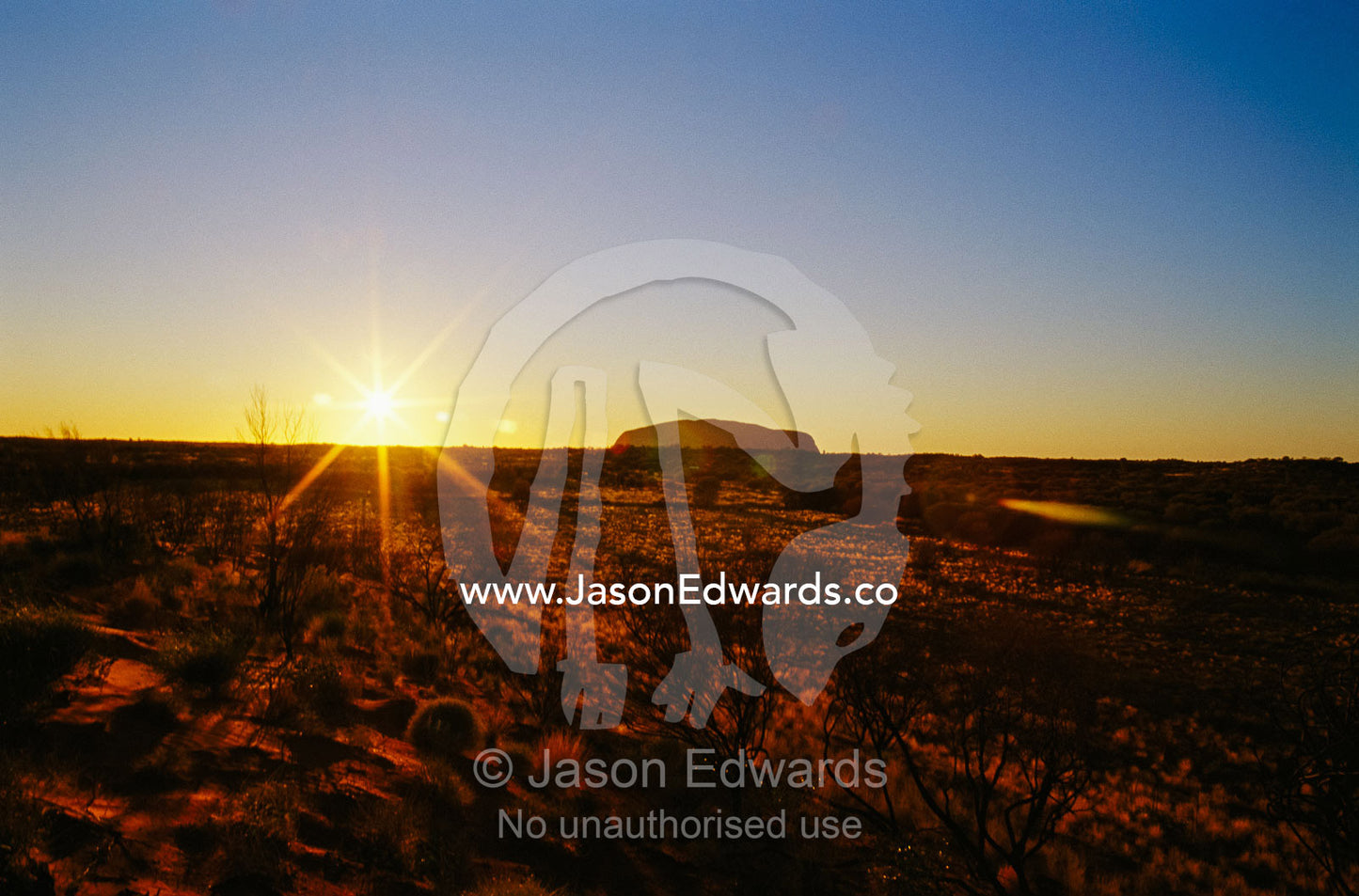 A view of Ayers Rock at sunset. Ayers Rock, Uluru National Park, Northern Territory, Australia.