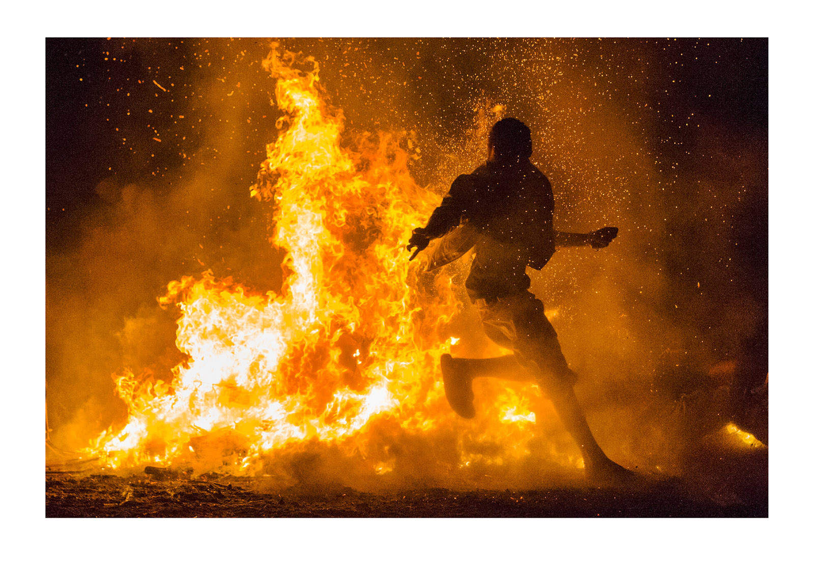 A villager taunts the flames and their gods during a tribal fire ceremony. Rabaul, New Britain, Papua New Guinea.