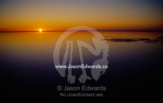 Sunset afterglow reflected on the mirrored surface of Lake Eyre. Lake Eyre National Park, South Australia.