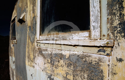 A weathered old trailer with peeling paint in the Australian outback. Konalda Station, Nullarbor Plain, South Australia.