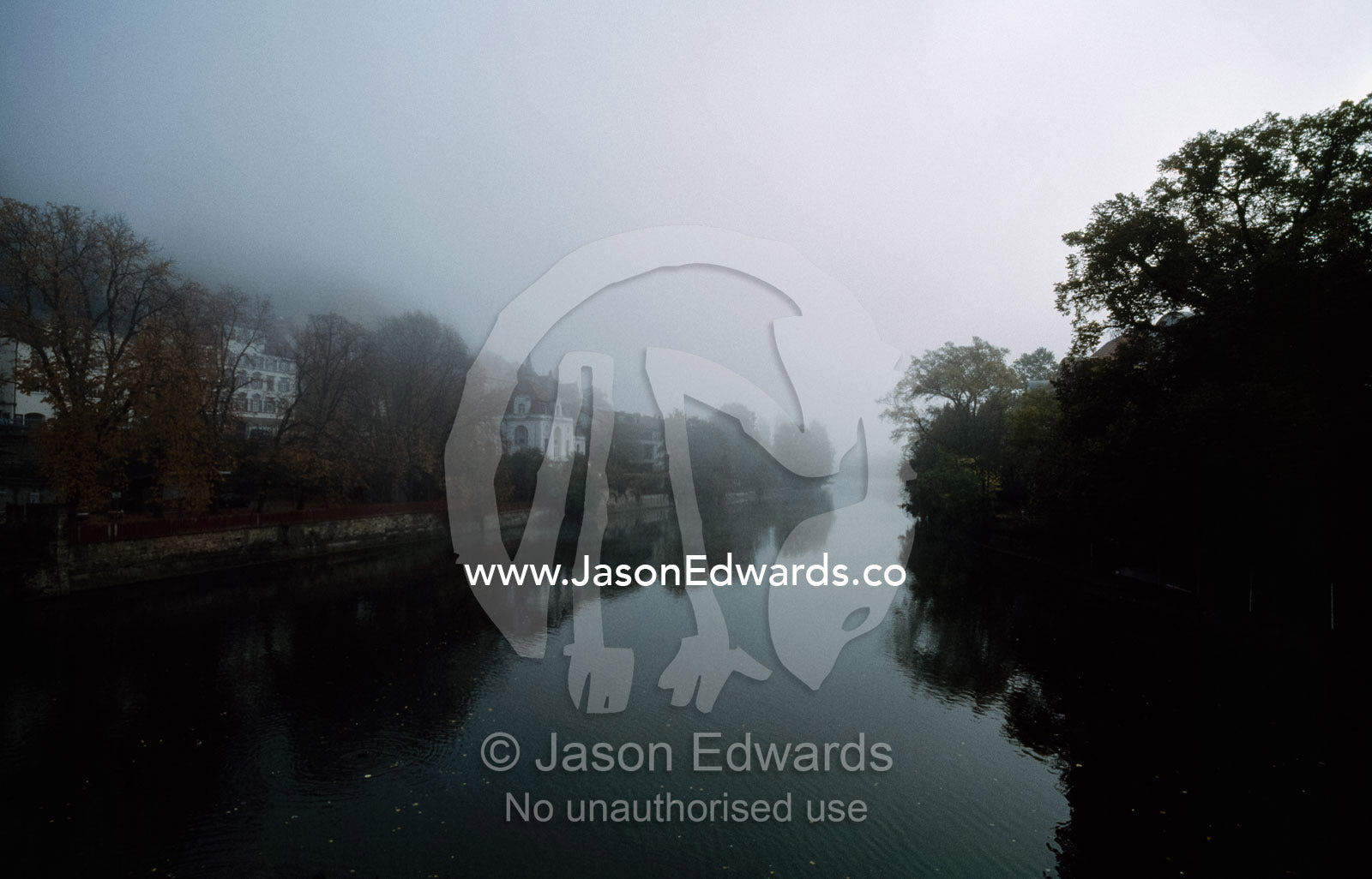 Fog envelops buildings on the Neckar River at Tubingen at dawn.   Tubingen, Baden-Wurttemberg, Germany.