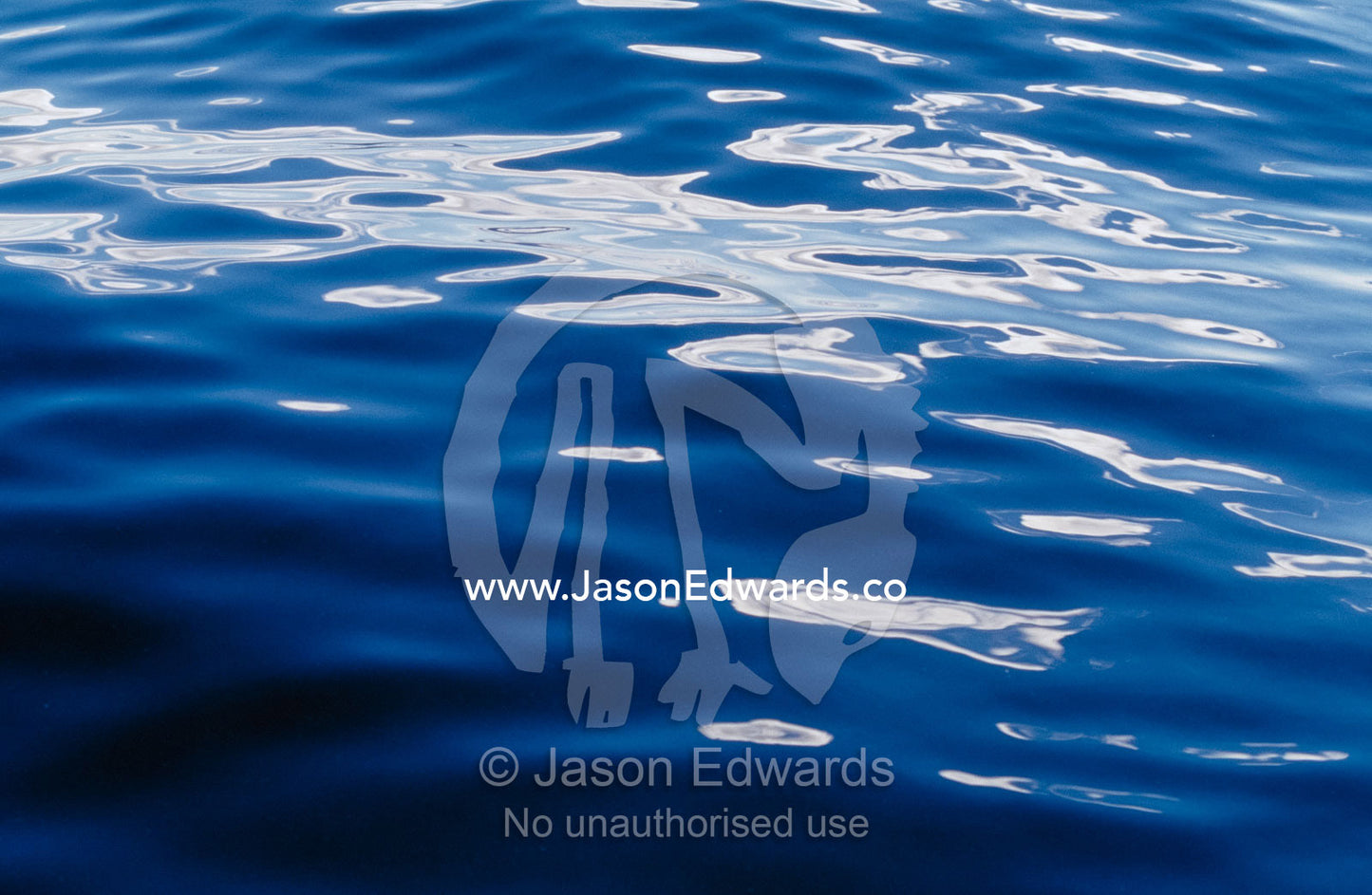 Reflections on a calm sea create abstract patterns and textures. Continental Shelf off Eden, New South Wales, Australia.