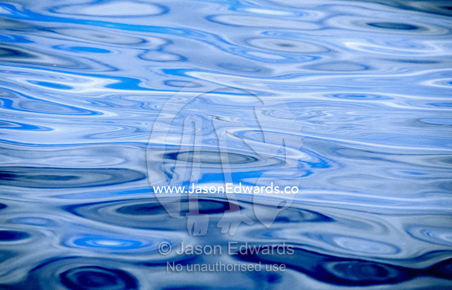 Reflections on a calm sea create abstract patterns and textures. Continental Shelf off Eden, New South Wales, Australia.
