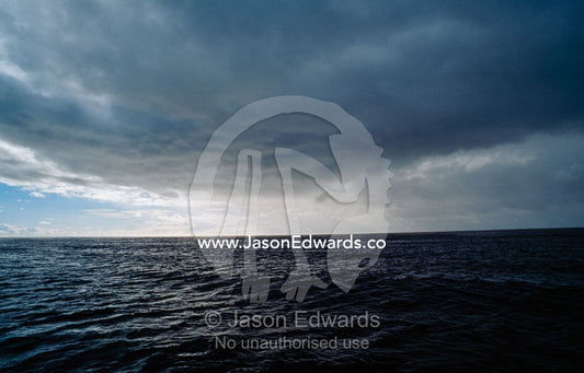 Heavy rain clouds and a menacing storm front over a gray ocean. Twofold Bay, Eden, New South Wales, Australia.