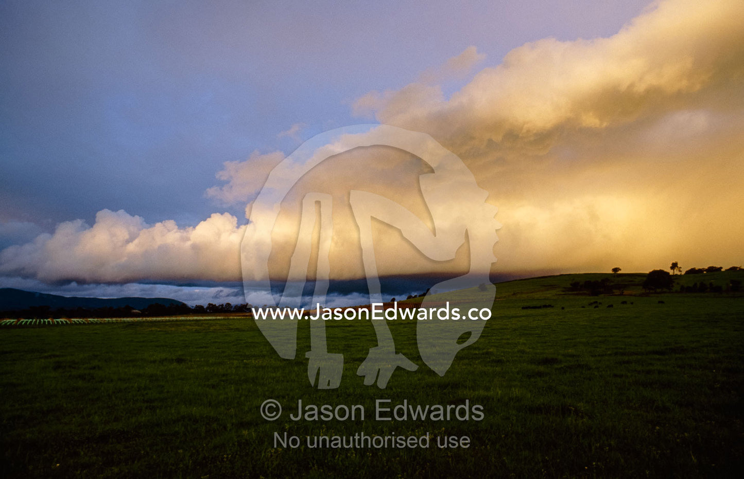 Storm clouds gather over farmland and vineyards. Yarra Valley, Victoria, Australia.