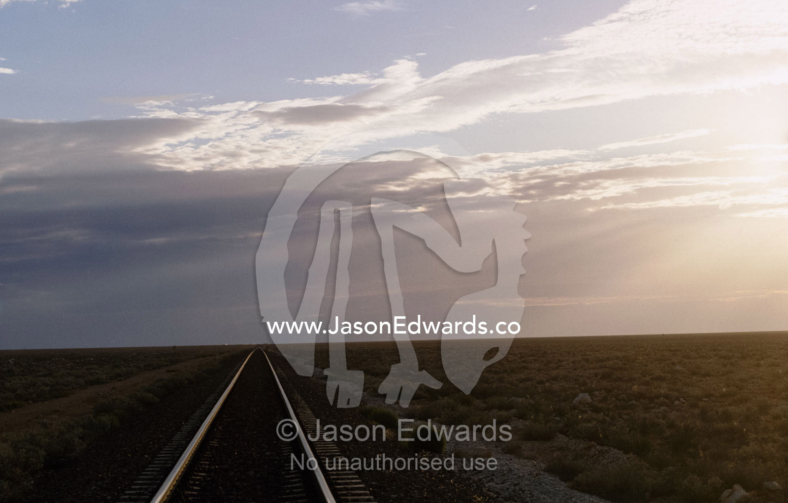 The trans continental railway track rolls across the outback desert. Nullarbor Plain, South Australia.
