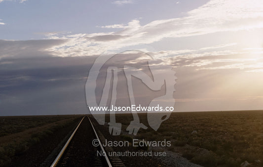The trans continental railway track rolls across the outback desert. Nullarbor Plain, South Australia.