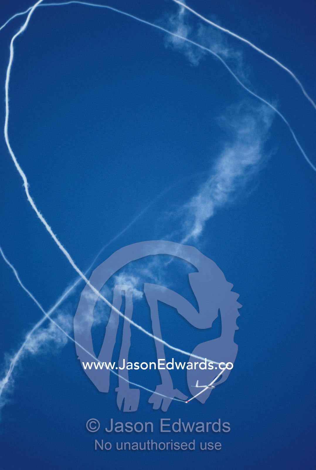 Salto stunt glider doing a loop whilst trailing smoke from it's wings. Avalon International Airshow, Victoria Australia