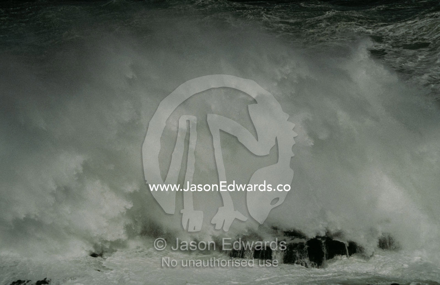 An immense wave crashes onto a rock shelf with destructive force. Phillip Island, Victoria Australia,