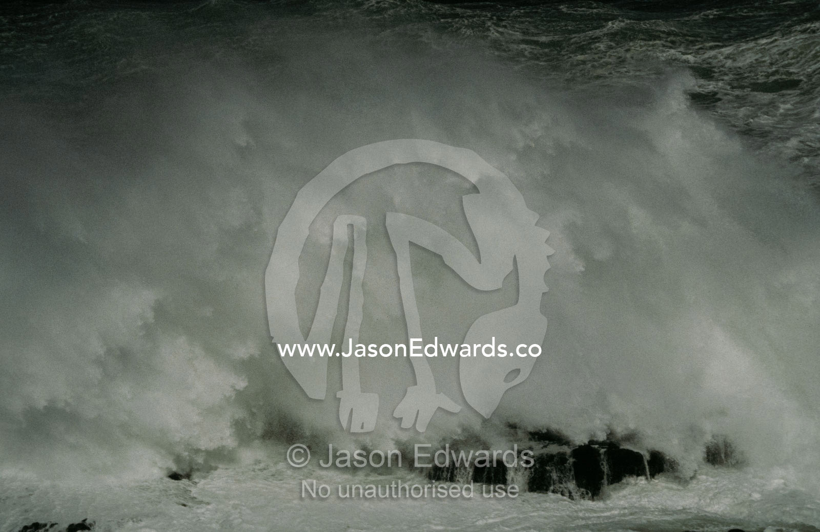 An immense wave crashes onto a rock shelf with destructive force. Phillip Island, Victoria Australia,