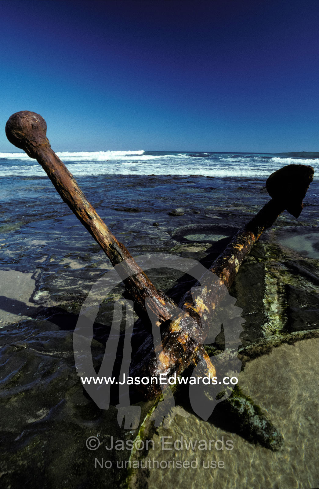 A nineteenth century shipwreck anchor on a remote and rugged beach. Moonlight Head Victoria Australia.
