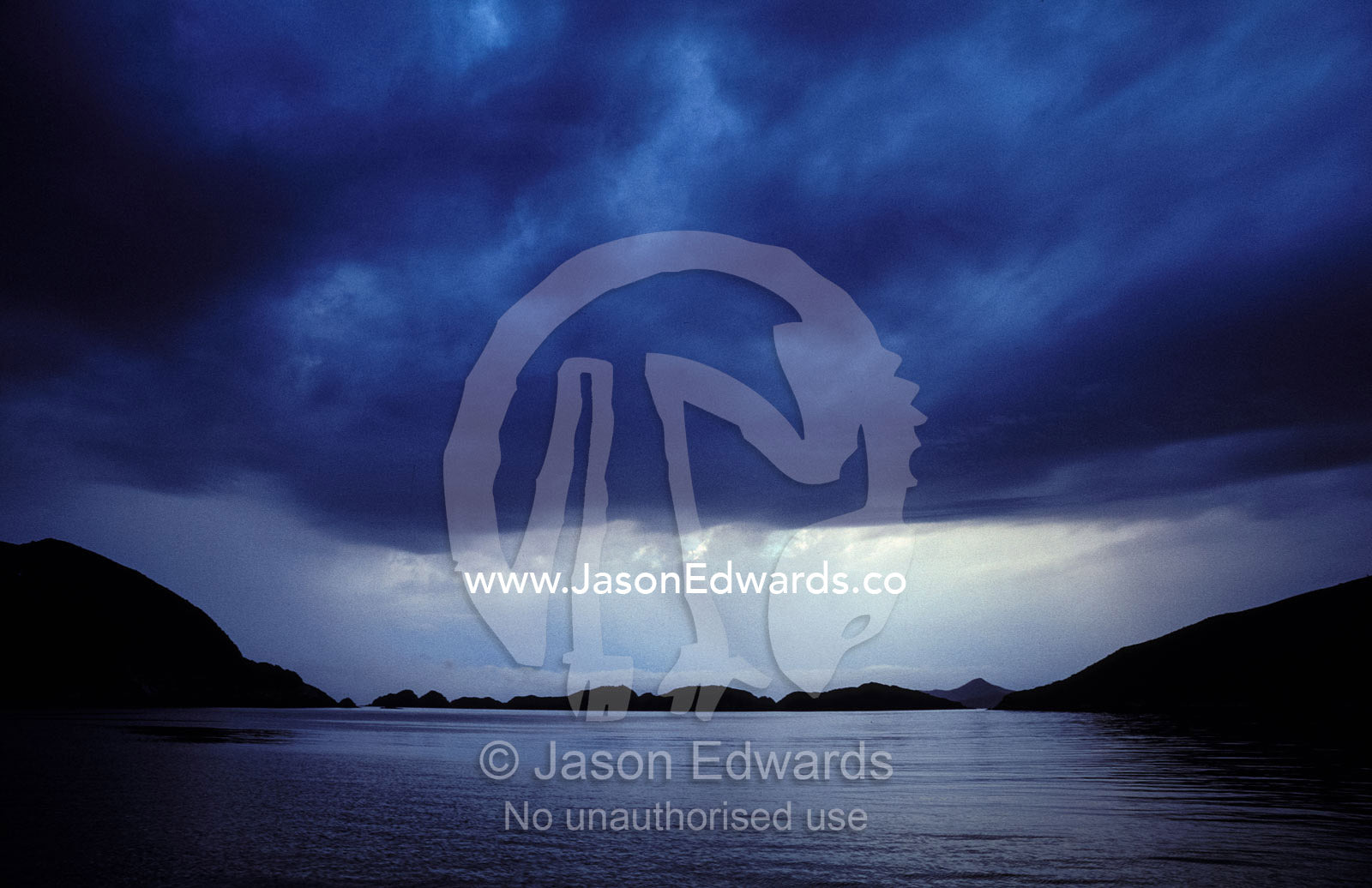 A rain storm descends on a remote and rugged coastal habour. South West National Park, Bathurst Habour, Tasmania.