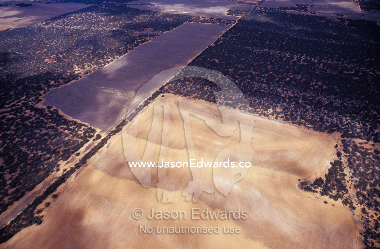 An aerial view of clouds casting shadows on drought-stricken farmland. North Eastern Outback South Australia.