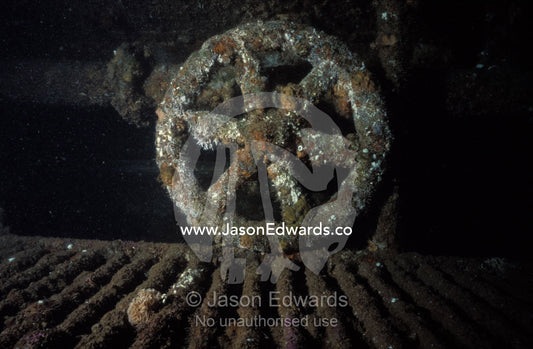 Engine room valve wheel of the shipwrecked barnacled Tasman Hauler. Twofold Bay, Eden, New South Wales, Australia.