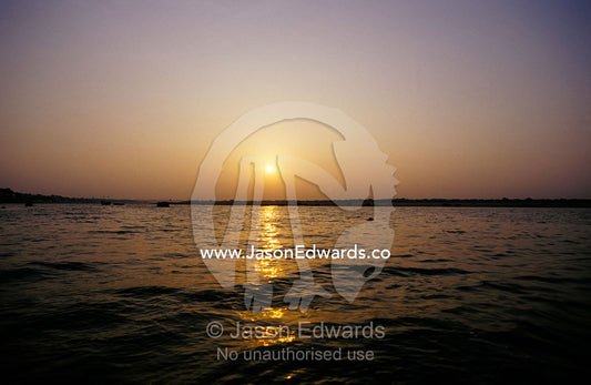 A peaceful scene of the Holy Ganges River aka the Ganga River at dawn. Varanassi, India.
