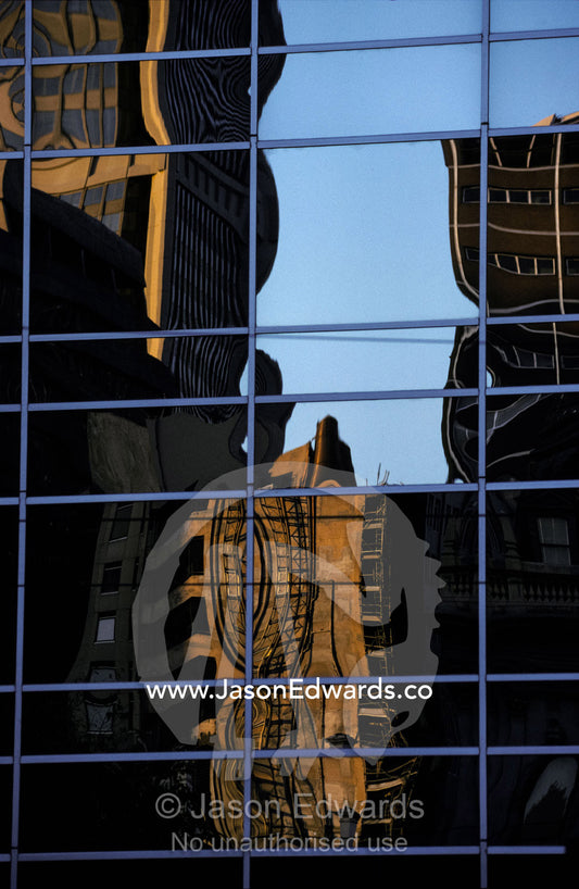 Abstract shapes are reflected in office building windows at days end. Melbourne Victoria Australia.