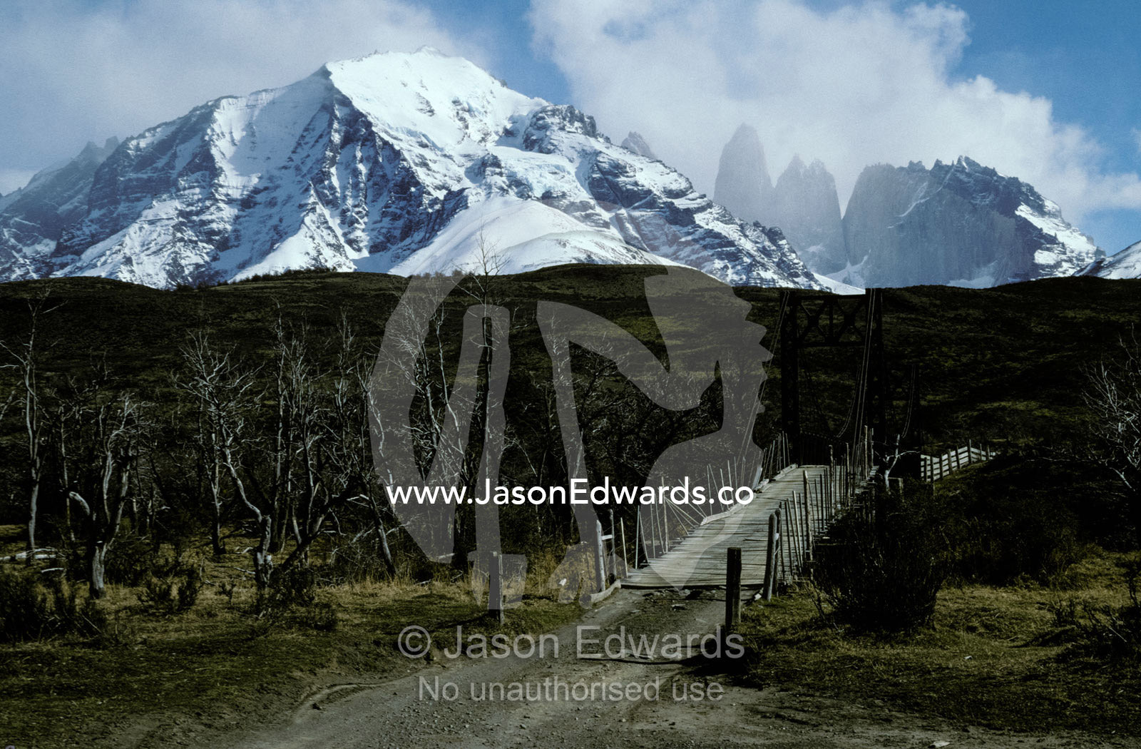 A remote wooden bridge in the icy wilderness of the Andes Mountains. Torres Del Paine National Park Biosphere Reserve Chile.