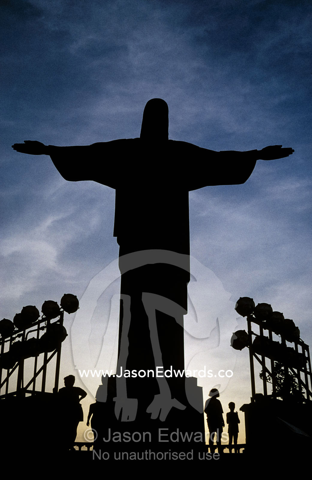 San Cristova, Christ, amidst flood lights and tourists at sunset. Rio de Janiero, Brasil