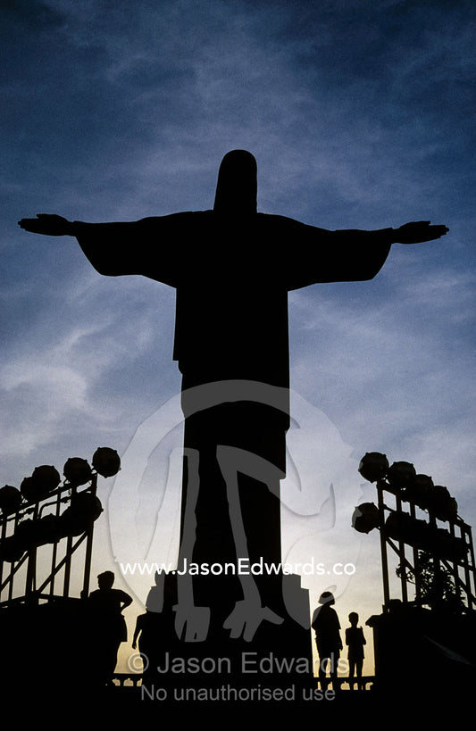 San Cristova, Christ, amidst flood lights and tourists at sunset. Rio de Janiero, Brasil