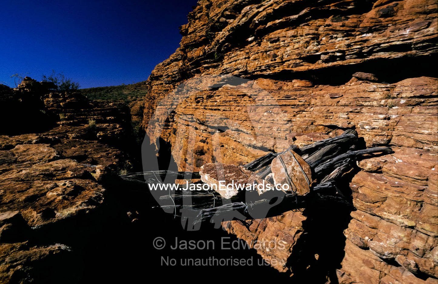 A precarious log foot bridge straddles one of Kings Canyon Gorges. Kings Canyon, Watarrka National Park Northern Territory, Australia.