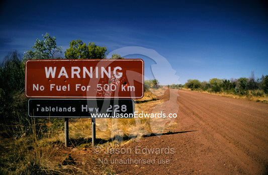 Cautionary fuel sign warning tourist of danger in the isolated outback Outback Southern Northern Territory, Australia.