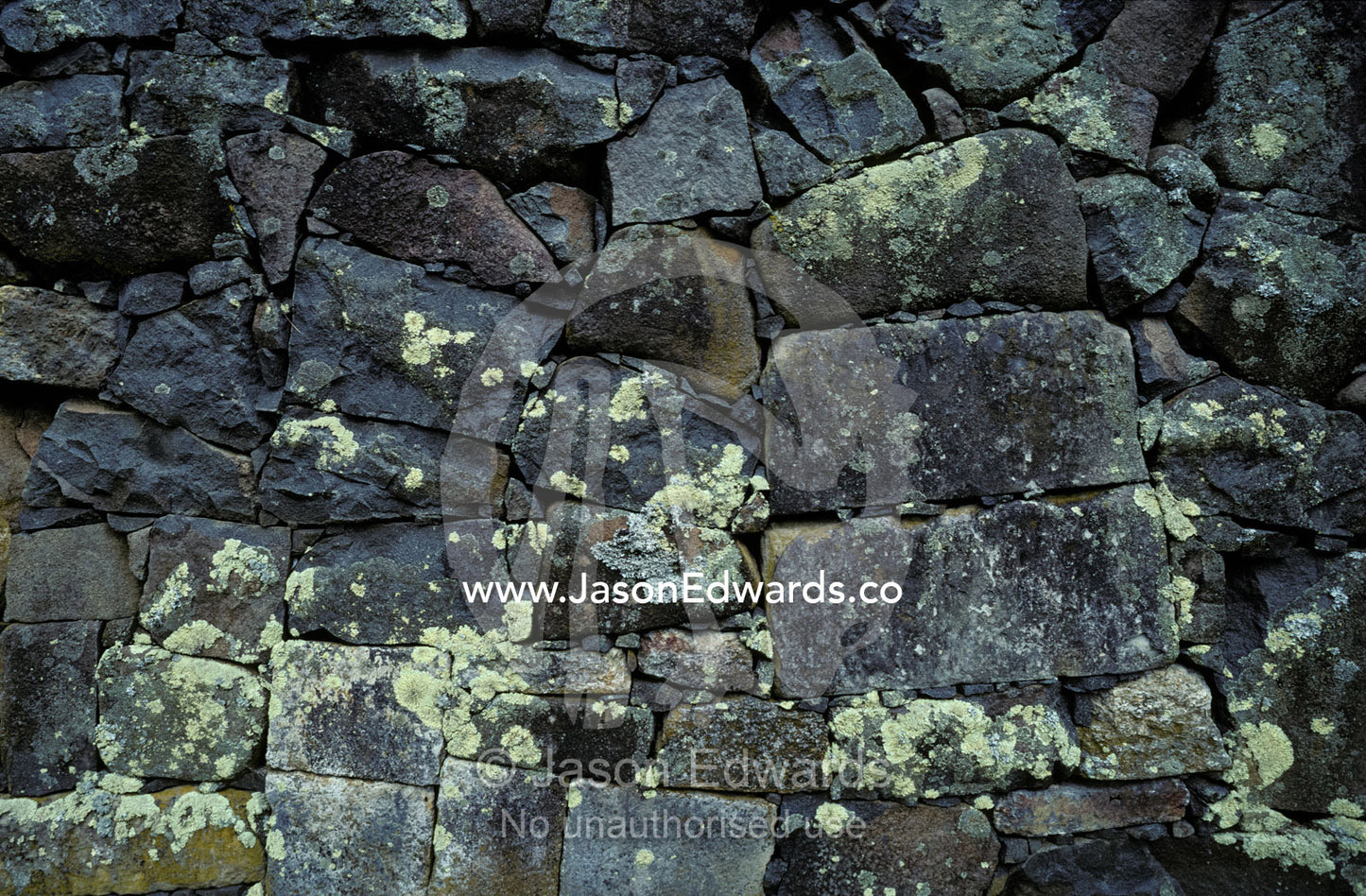 An antique granite wall constructed by convicts whilst in prison. Port Arthur Penal Settlement Tasmania Australia.