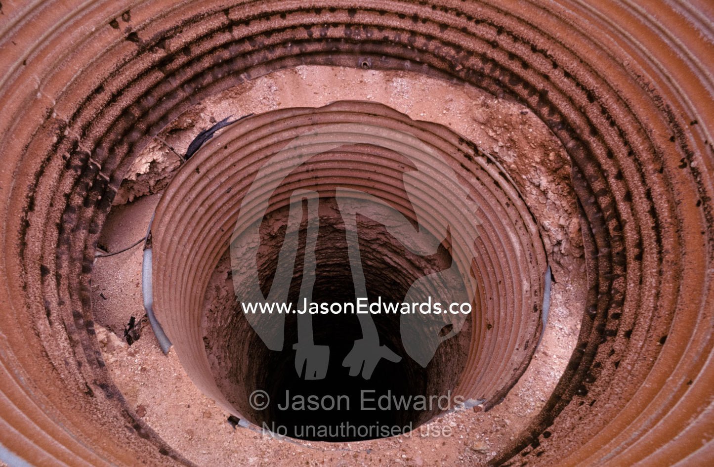 Circular tunnel entrance to an underground opal mine air shaft. Coober Peedy, South Australia.