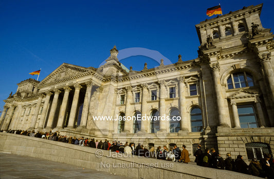 Tourists queue to view the New Reichstag on a sunny Autumn day. Berlin, Brandenburg, Germany.