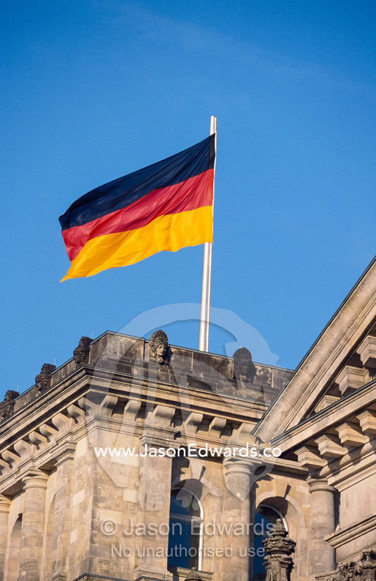 The German flag flies high above the new Reichstag in Berlin. Berlin, Brandenburg, Germany.