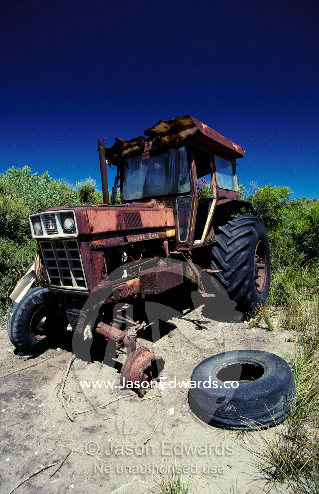 An abandoned tractor rusts away behind a coastal sand dune. Hanson Bay, Kangaroo Island, South Australia.