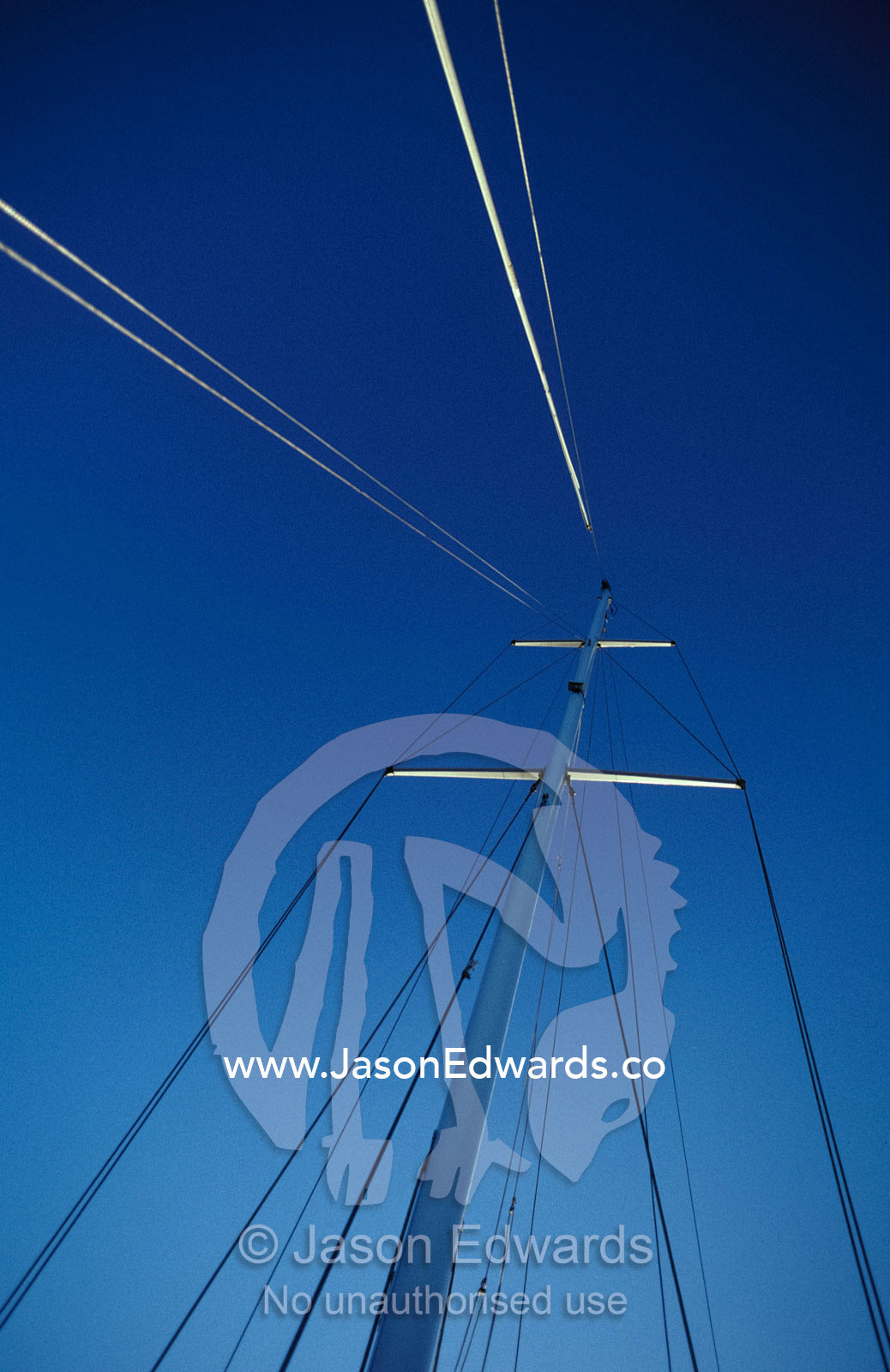 The mast, lines and ropes of a Catamaran against a clear blue sky. Kangaroo Island, Western River Cove, South Australia.