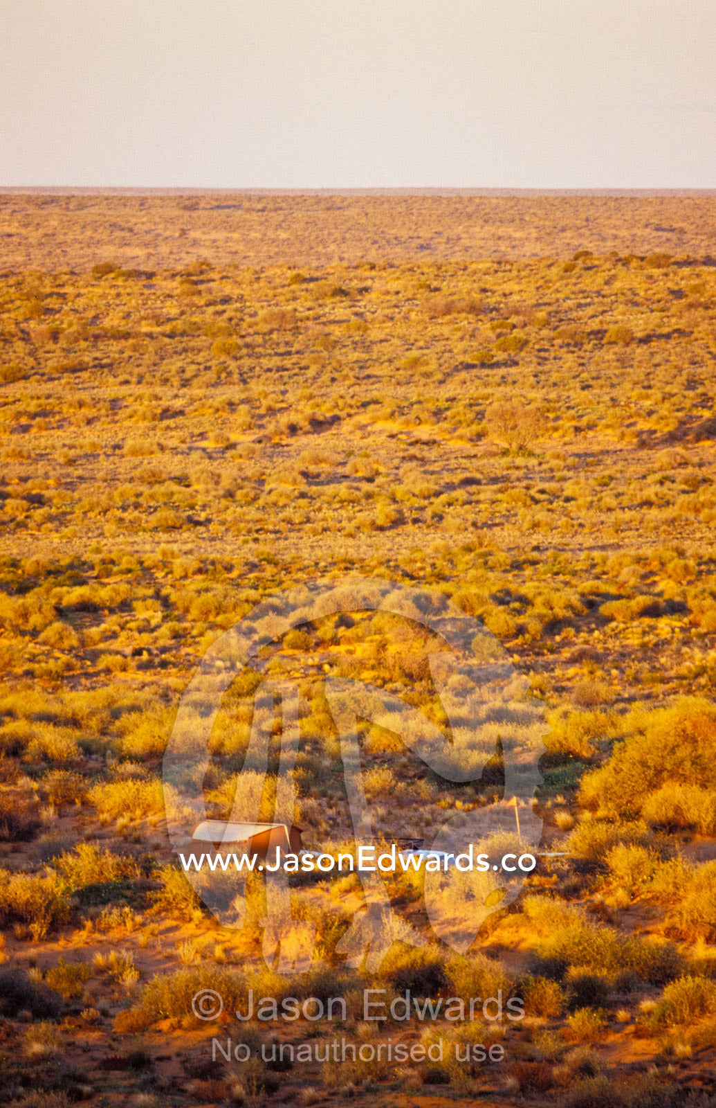 A remote, isolated camp site in the desert sand dunes at sunset. Simpson Desert Conservation Park, South Australia.