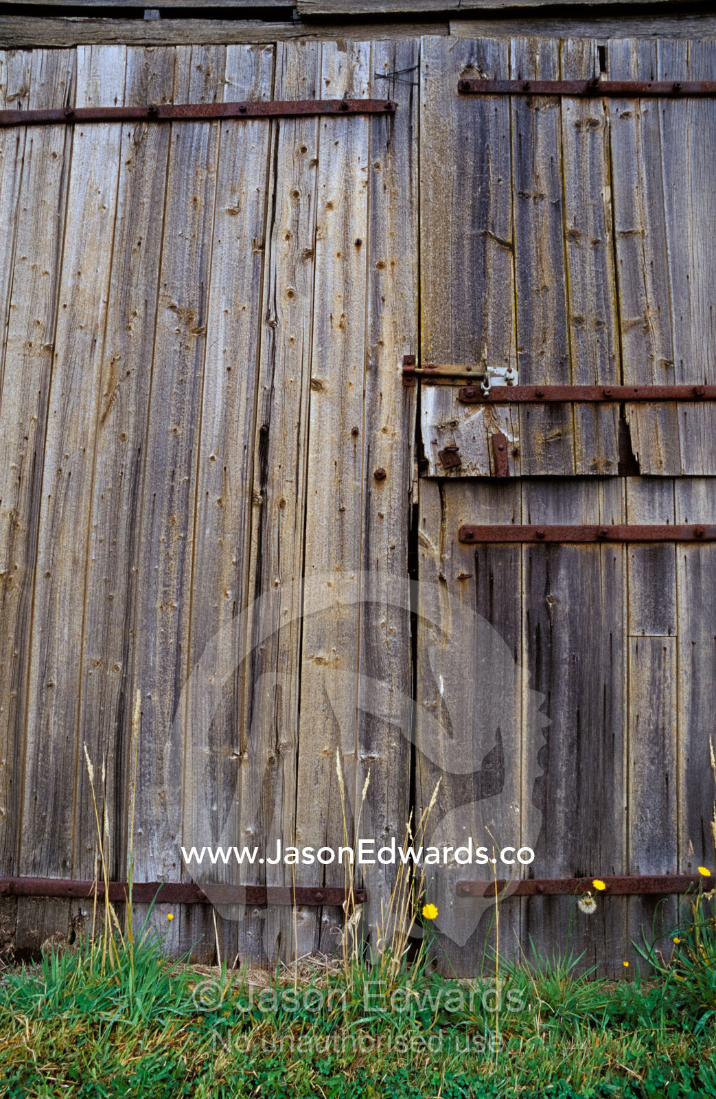 Dilapidated antique timber doors and bolts, on a wooden barn. Linton, Victoria, Australia.