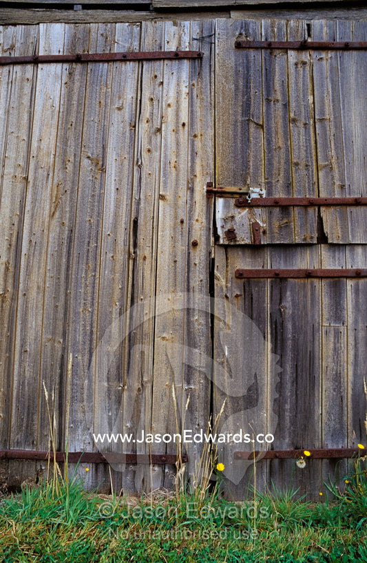 Dilapidated antique timber doors and bolts, on a wooden barn. Linton, Victoria, Australia.