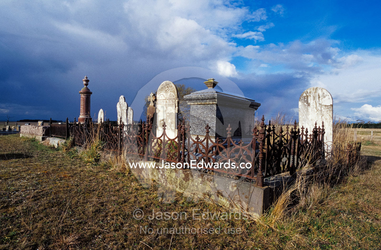 A country cemetery with historic grave stones, surrounded by a field. Cressy, Tasmania, Australia.