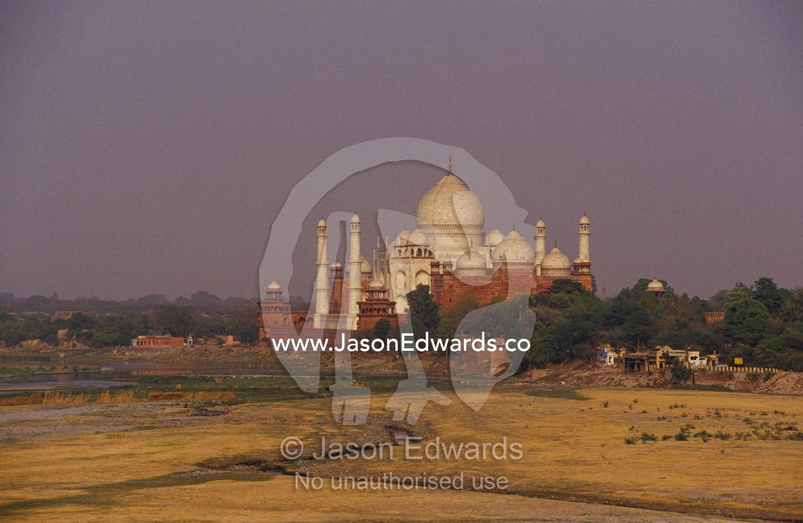 The Taj Mahal domes and Yamuna River floodplain from the Agra Fort. Agra, India.