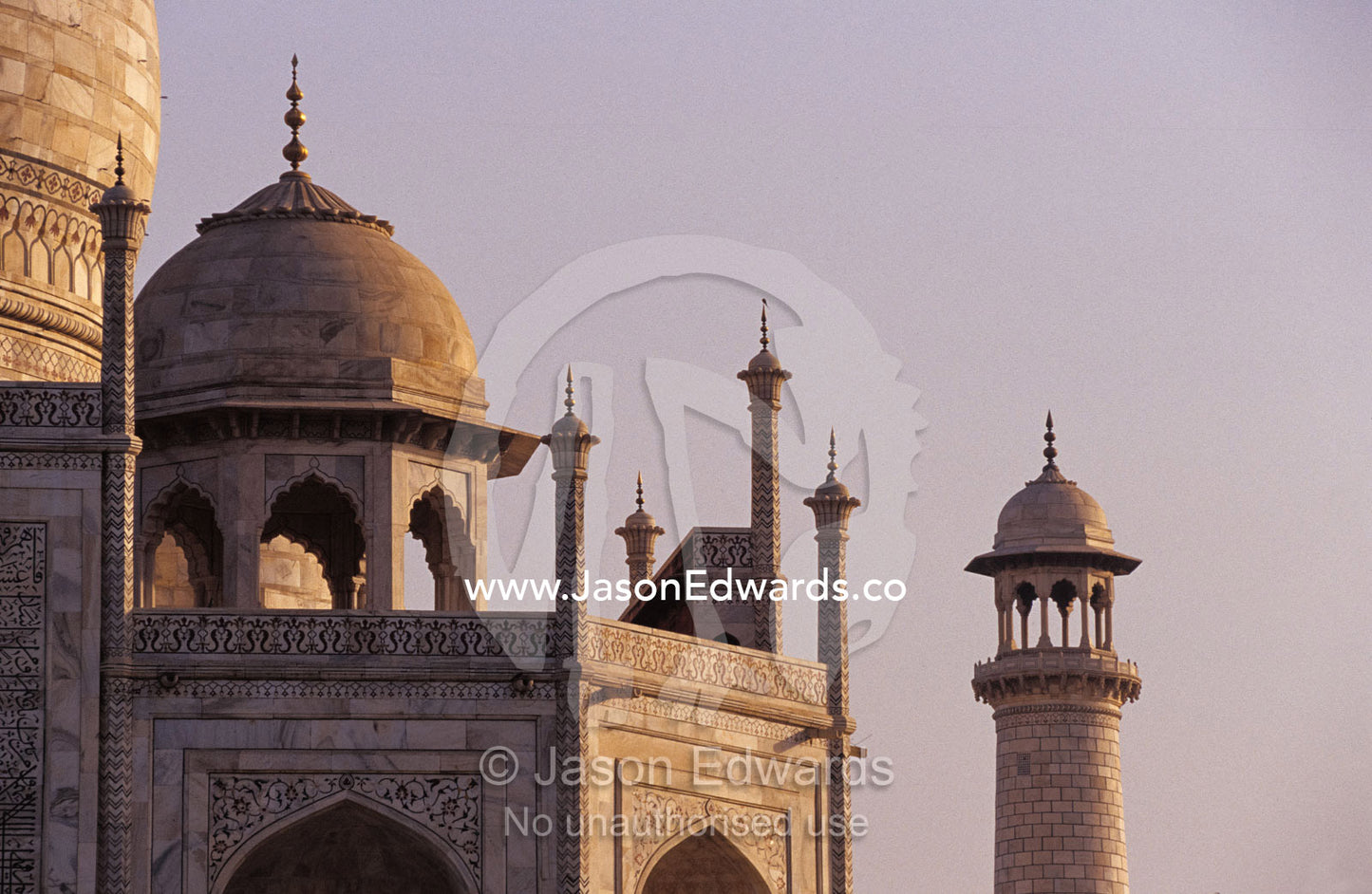 The Taj Mahal marble domes with Pietra Dura inlay and minaret at dawn. Agra, India.