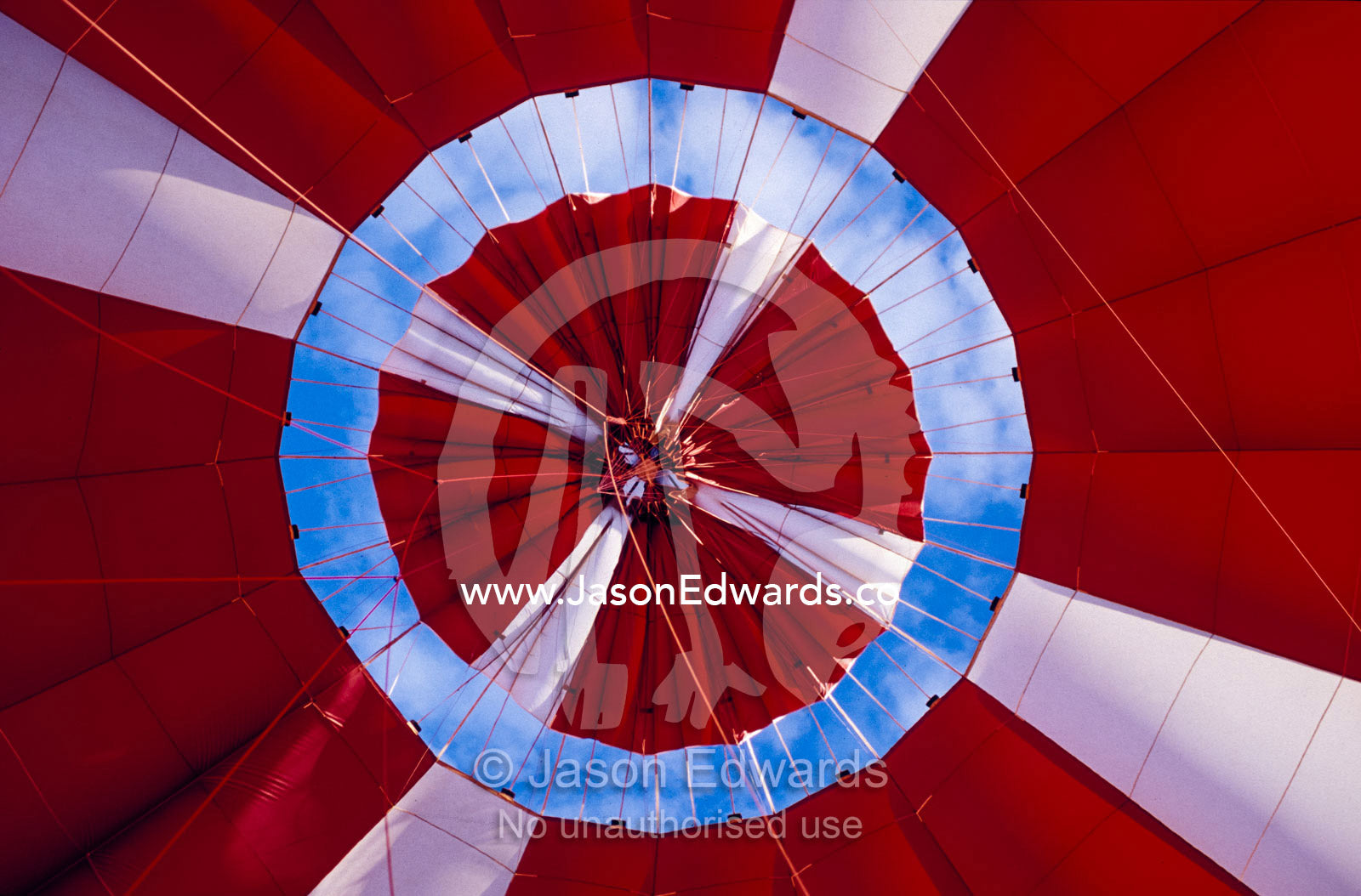 The inflated red canopy of a Hot Air Balloon with the blue sky behind. Yarra Valley, Victoria, Australia.