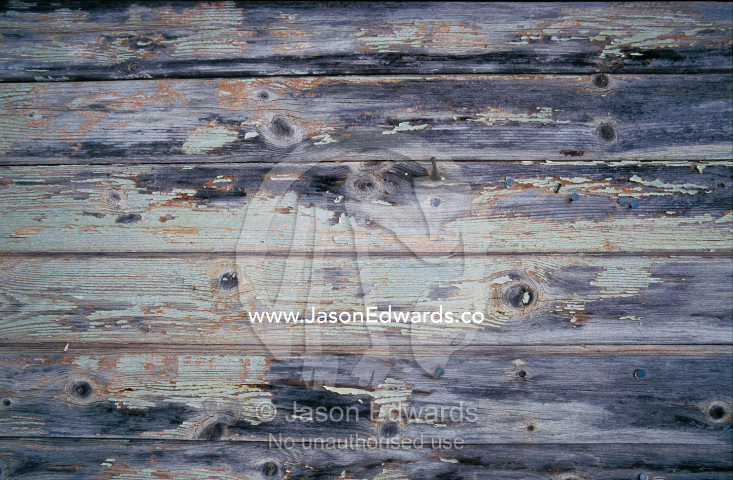 Paint peeling off the planks of an old country house. Wedderburn, Victoria, Australia.