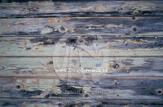 Paint peeling off the planks of an old country house. Wedderburn, Victoria, Australia.