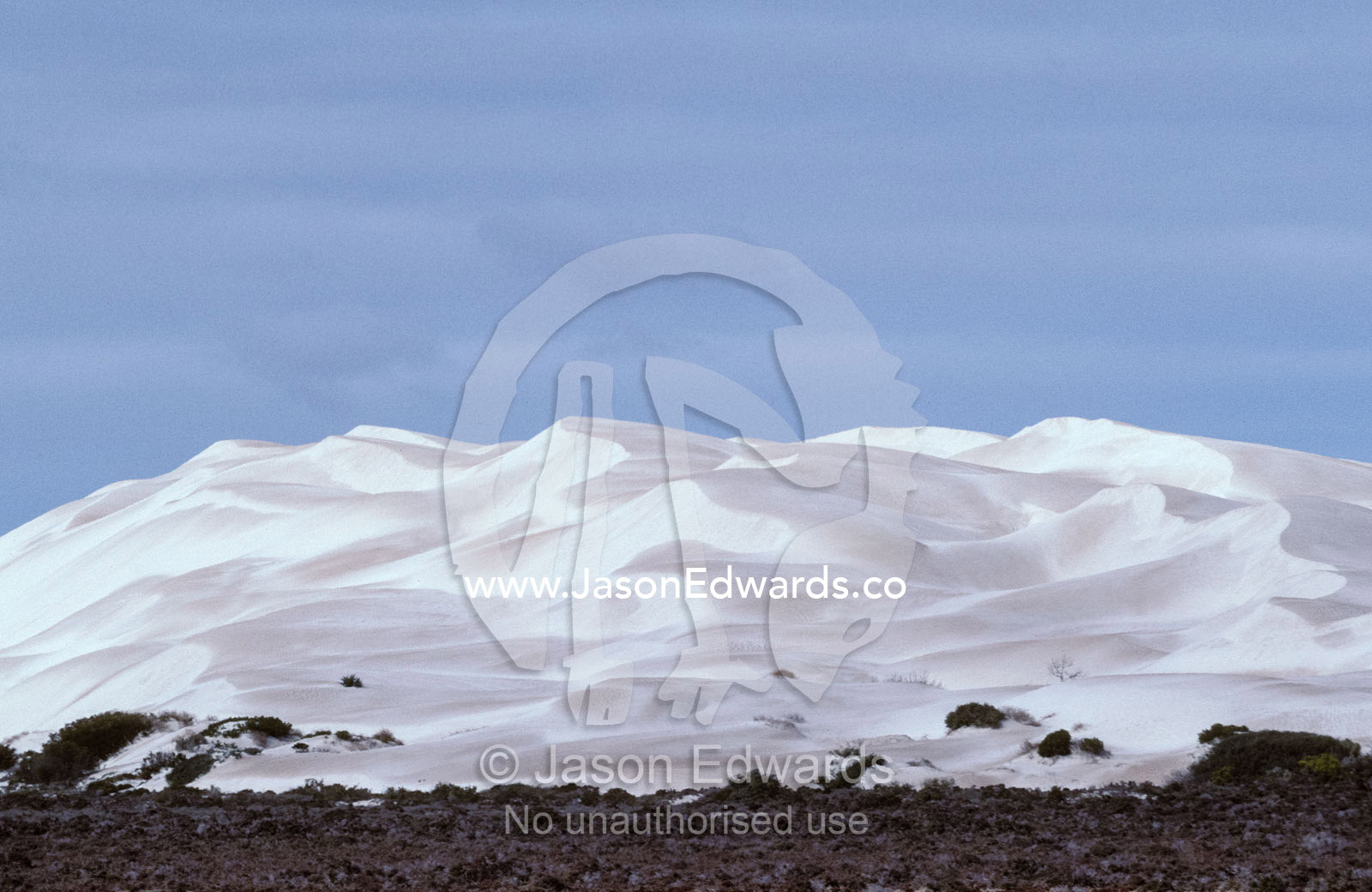 Sunlight reflecting off blinding white coastal sand dunes at midday. Near Cactus Beach, South Australia.