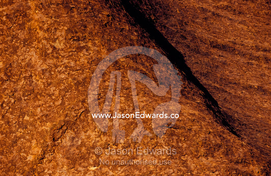 The rust oxidisation on the sandstone surface of Uluru, Ayres Rock. Uluru, Kata Tjuta National Park, Northern Territory, Australia.