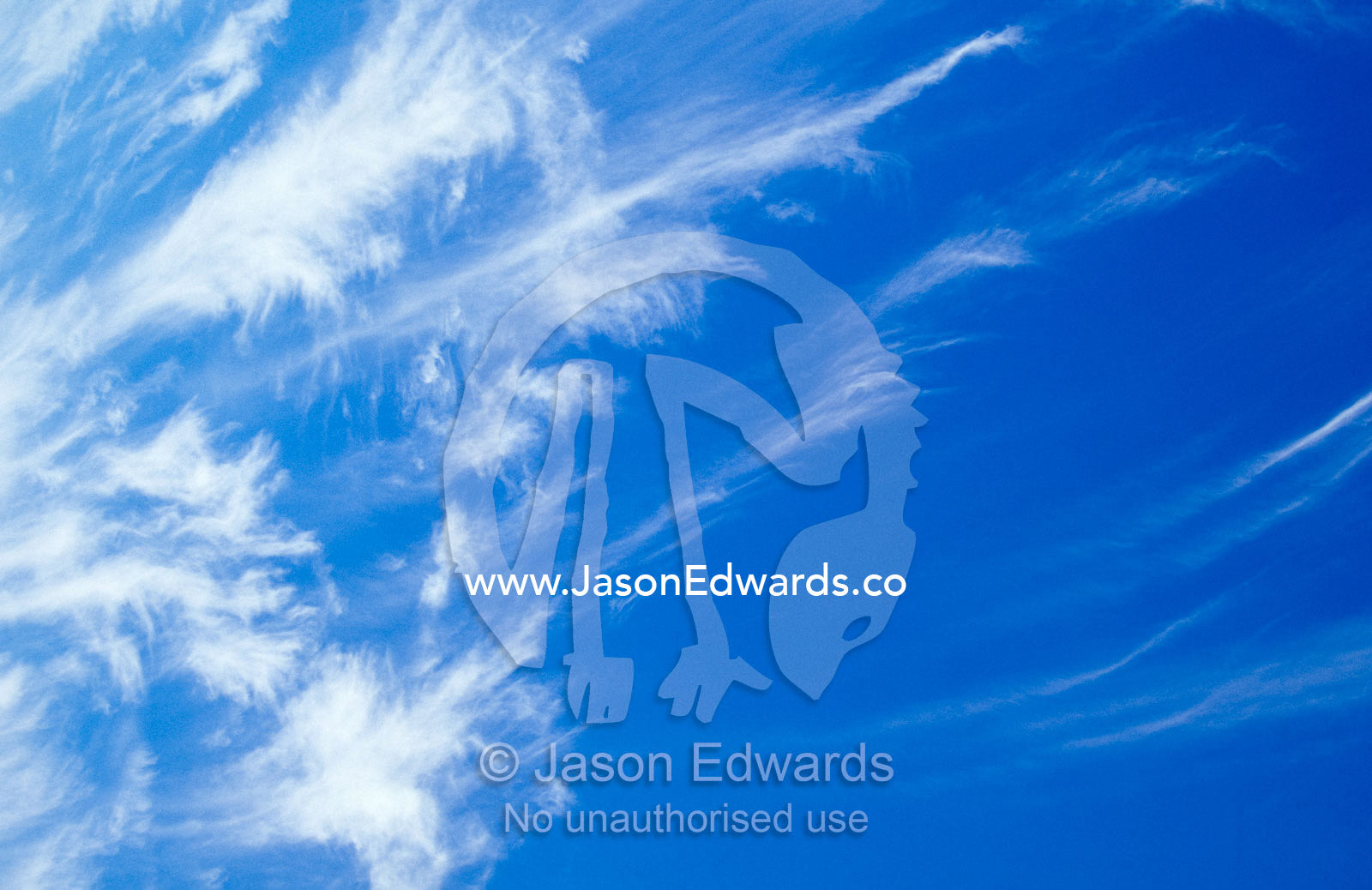 Whispy stark white Cirrus clouds in a vast blue sky. South West Conservation Area, Tasmania, Australia.