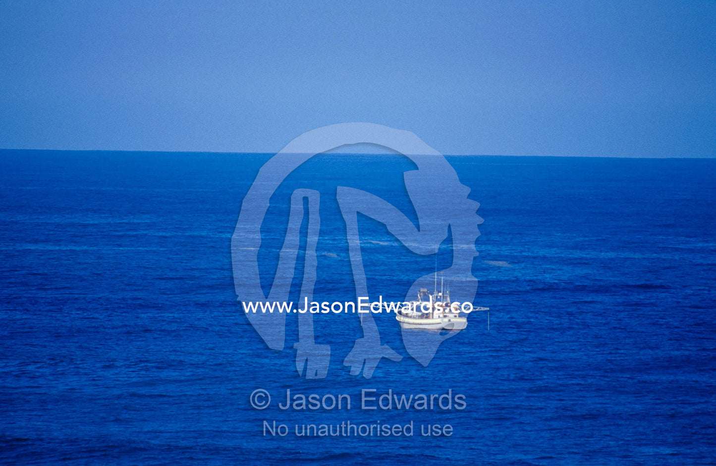A Scallop Fishing Boat at sea in a vast blue ocean. South West Conservation Area, Tasmania, Australia.