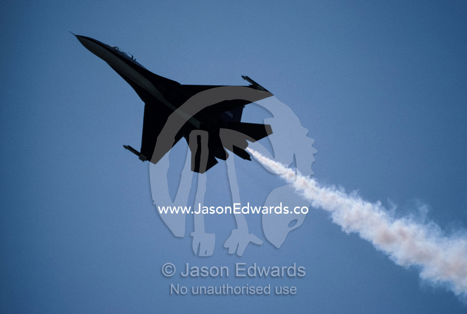 An SU27 Russian Jet Fighter trailing smoke as it races across the sky. Avalon International Airshow, Victoria, Australia.