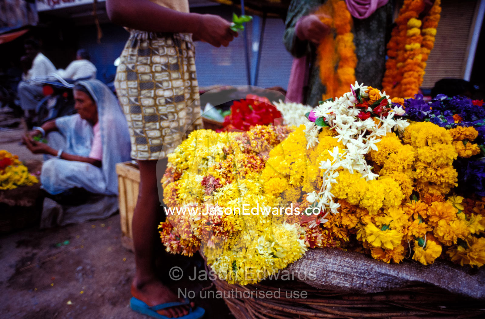 A colorful marigold flower display at a market stall in the Old City. Varanassi, India.