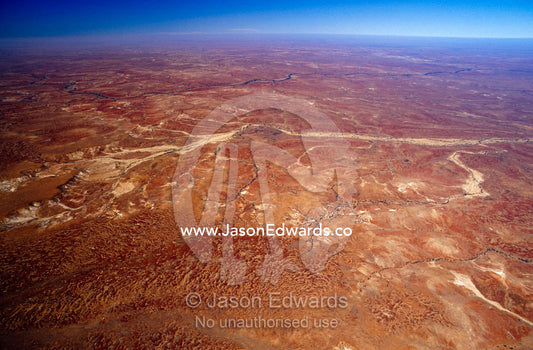 A vast desert scoured by dry river beds after flood waters evaporated. between Lake Eyre National Park and Oodnadatta, South Australia, Australia.