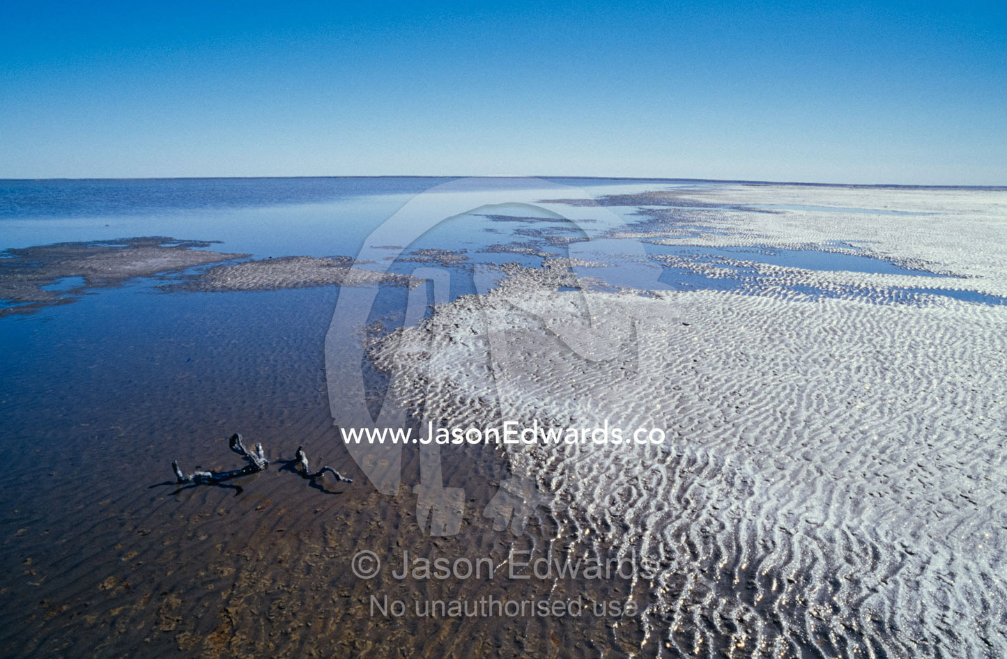 Flooded desert Salt Lake and crystallised salt crust on the shoreline. Lake Eyre South National Park, South Australia.