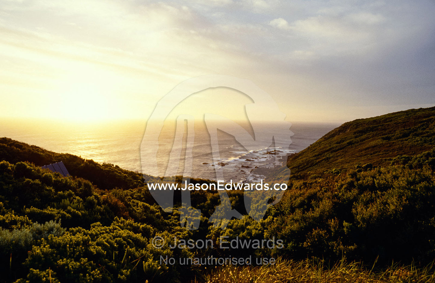 A hidden roof top overlooks a scenic coastal sunset. Cape Otway National Park, Victoria, Australia.