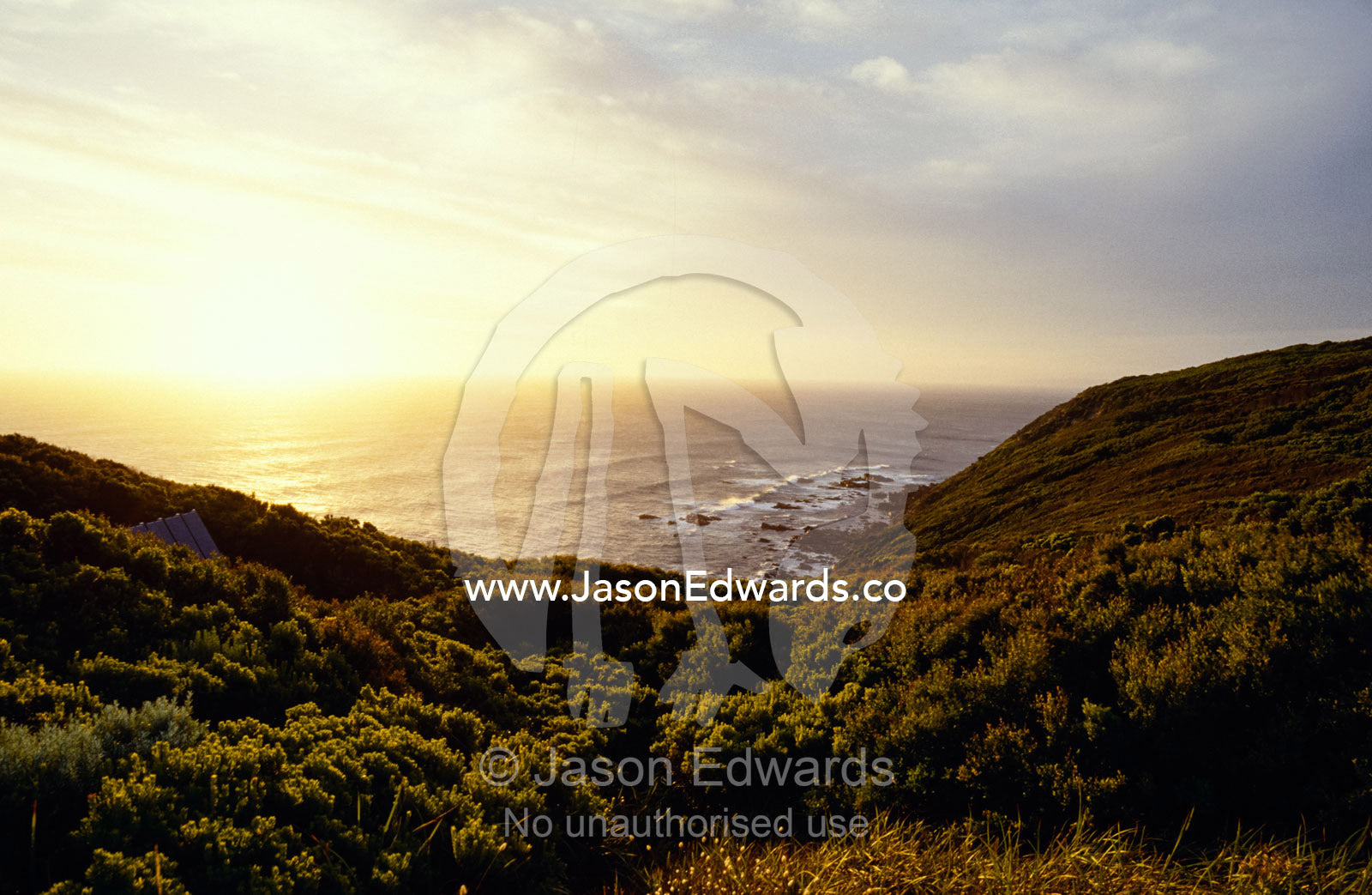 A hidden roof top overlooks a scenic coastal sunset. Cape Otway National Park, Victoria, Australia.